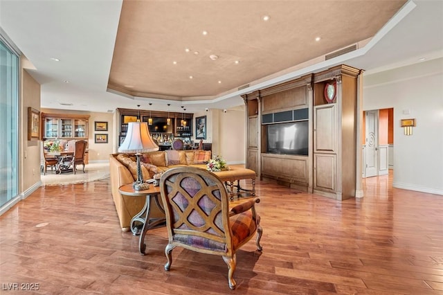 dining space featuring a tray ceiling and light hardwood / wood-style floors