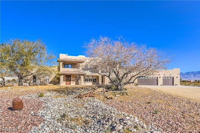 view of front of house featuring a mountain view and a garage