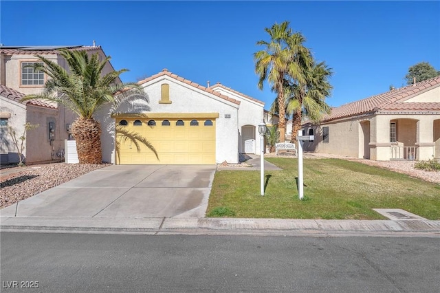 mediterranean / spanish-style house featuring a garage and a front lawn