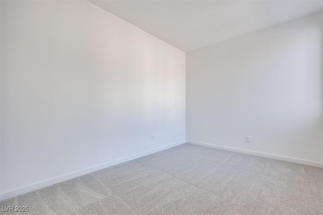 carpeted empty room featuring lofted ceiling