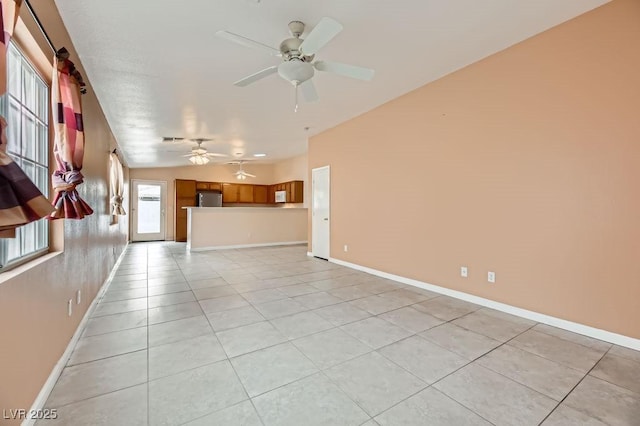 unfurnished living room featuring ceiling fan and light tile patterned flooring