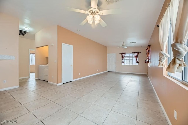 interior space featuring light tile patterned floors, washer / dryer, and ceiling fan