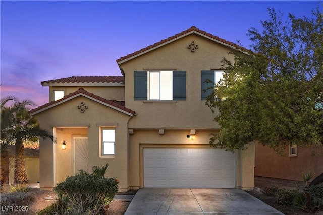 mediterranean / spanish-style house with a garage