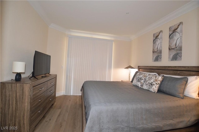 bedroom with ornamental molding and light hardwood / wood-style floors