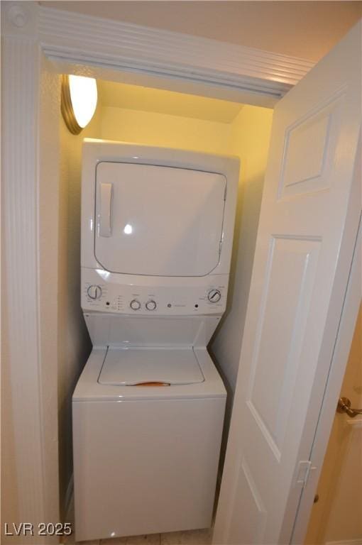 laundry room with stacked washing maching and dryer