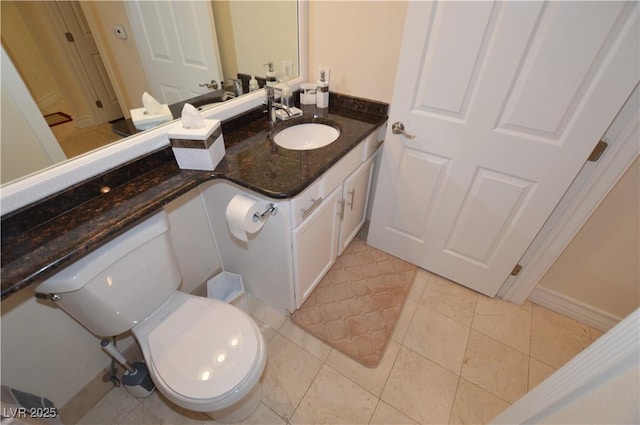 bathroom with tile patterned flooring, vanity, and toilet