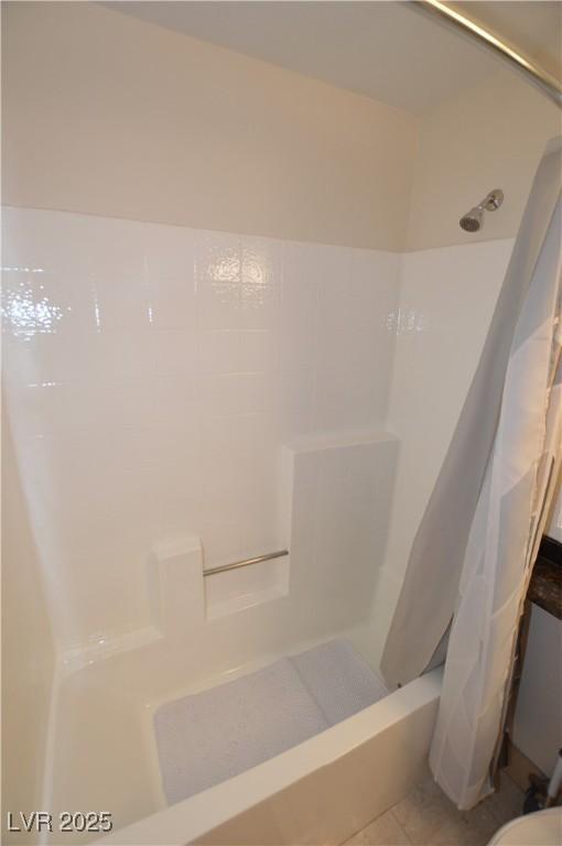 bathroom featuring tile patterned flooring and shower / tub combo