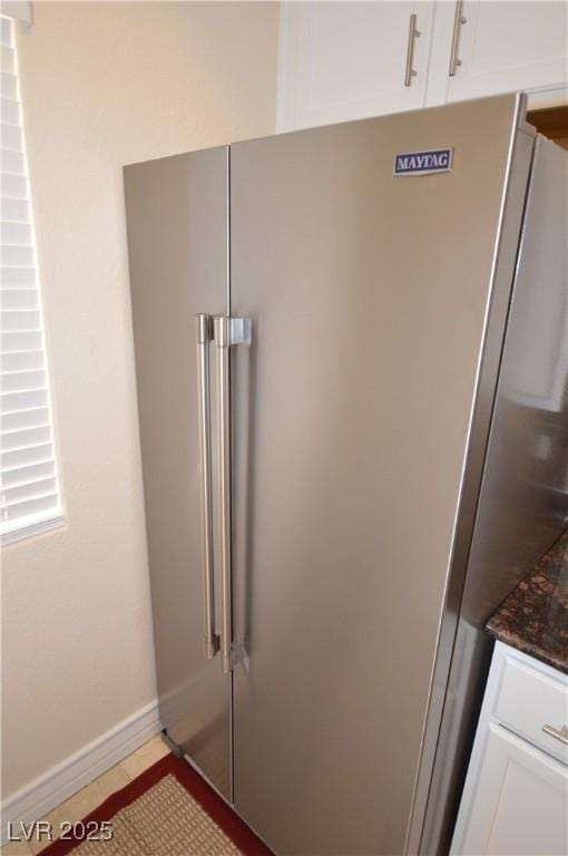 interior details with high end refrigerator and white cabinets