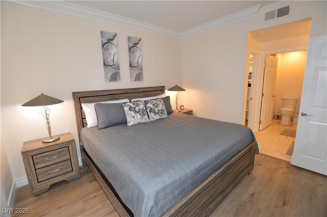 bedroom featuring crown molding, connected bathroom, and light hardwood / wood-style flooring