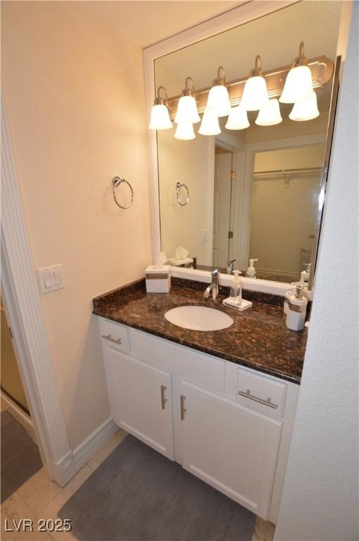 bathroom featuring tile patterned flooring and vanity