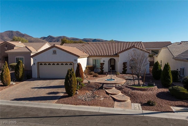 mediterranean / spanish house featuring a garage and a mountain view