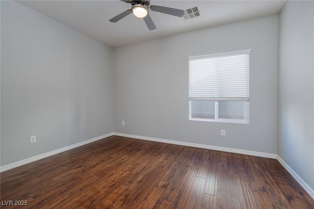 unfurnished room with dark wood-type flooring and ceiling fan