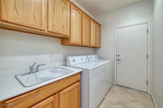 laundry room featuring cabinets, washer and clothes dryer, sink, and light tile patterned floors