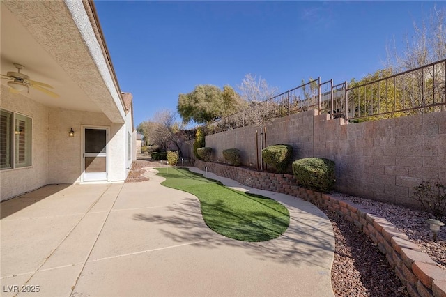 view of yard featuring ceiling fan and a patio area