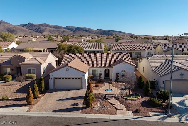 view of front of home with a garage and a mountain view