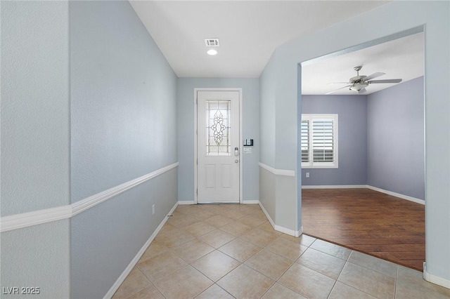 tiled entryway with ceiling fan