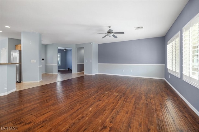 unfurnished living room featuring wood-type flooring and ceiling fan