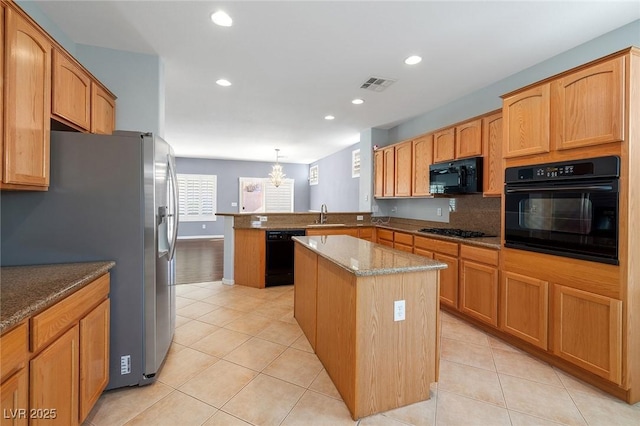 kitchen featuring black appliances, sink, hanging light fixtures, a center island, and kitchen peninsula