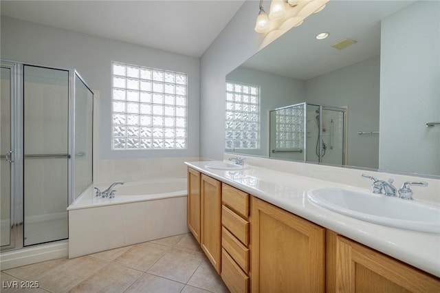 bathroom featuring tile patterned flooring, plus walk in shower, and vanity