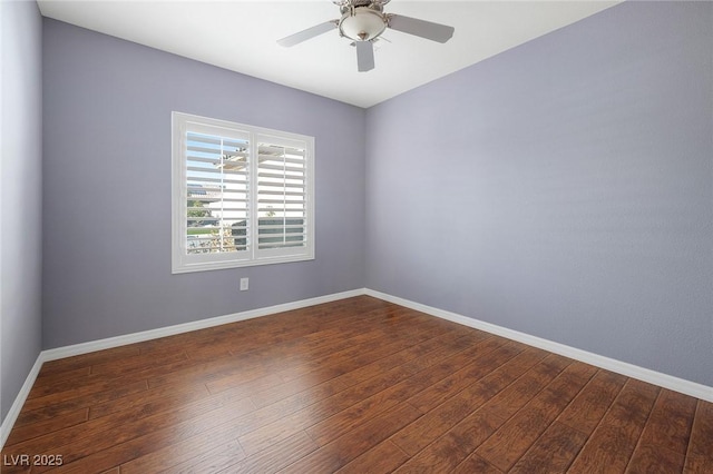 empty room with ceiling fan and dark hardwood / wood-style flooring