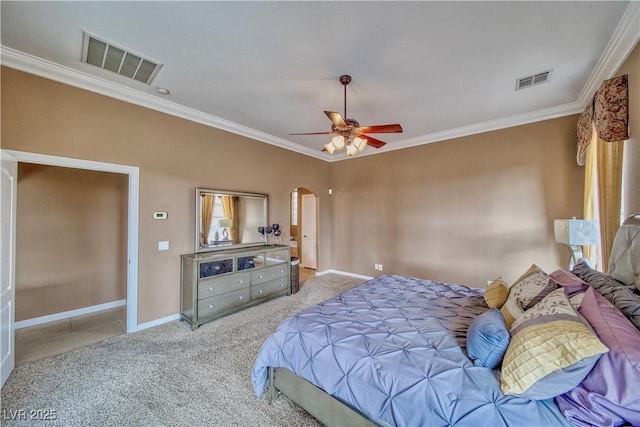 bedroom featuring ornamental molding, arched walkways, and visible vents