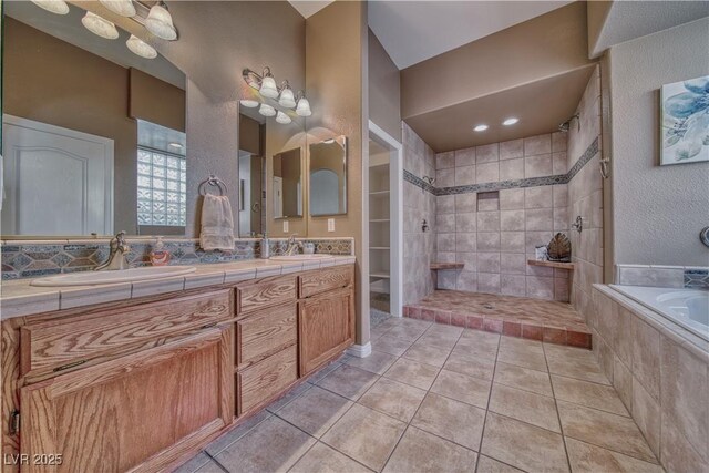 bathroom featuring tile patterned floors, vanity, and plus walk in shower