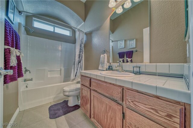 full bathroom with tile patterned floors, toilet, vanity, and shower / bath combo