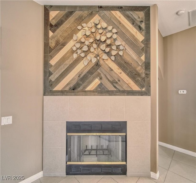 details featuring baseboards and a tile fireplace