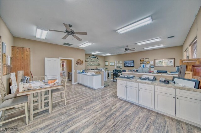 kitchen featuring white cabinetry, ceiling fan, and light wood-type flooring