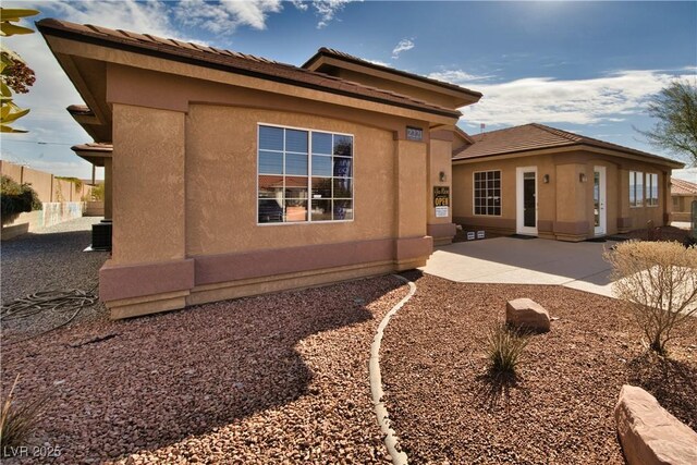 view of property exterior featuring a patio and central air condition unit