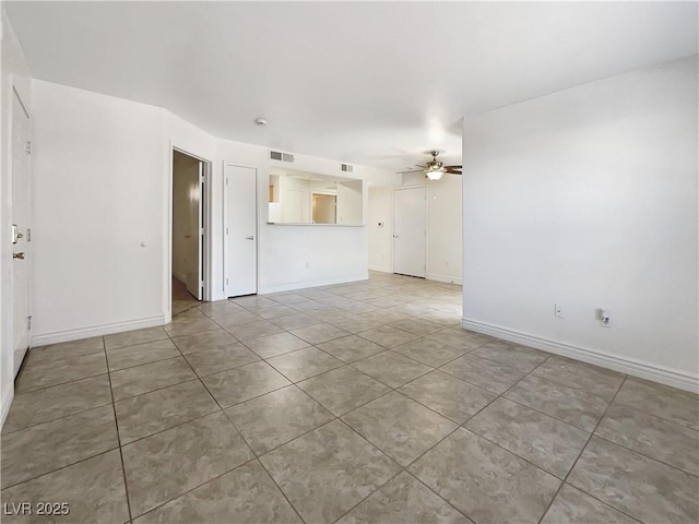 spare room featuring tile patterned flooring and ceiling fan