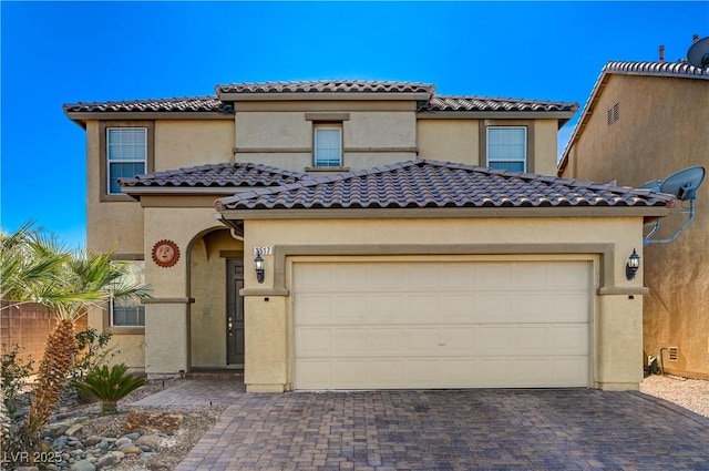 mediterranean / spanish-style home featuring a garage