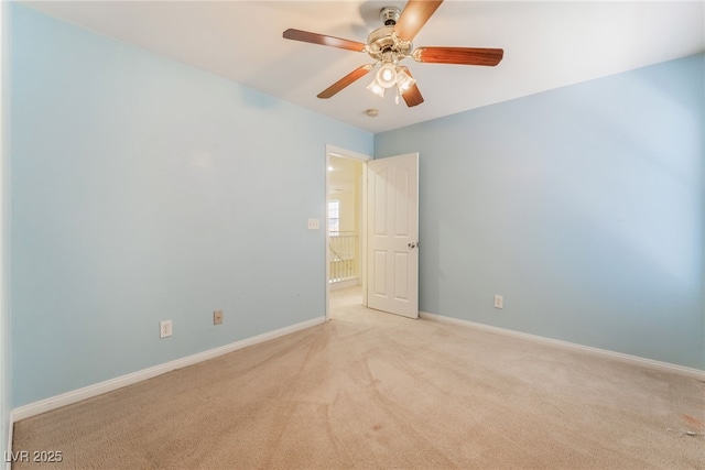 empty room with light carpet, ceiling fan, and baseboards