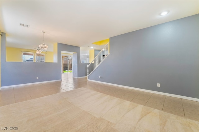 tiled empty room featuring visible vents, a notable chandelier, stairway, and baseboards