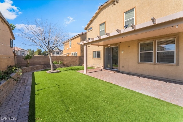 view of yard featuring a patio area and a fenced backyard