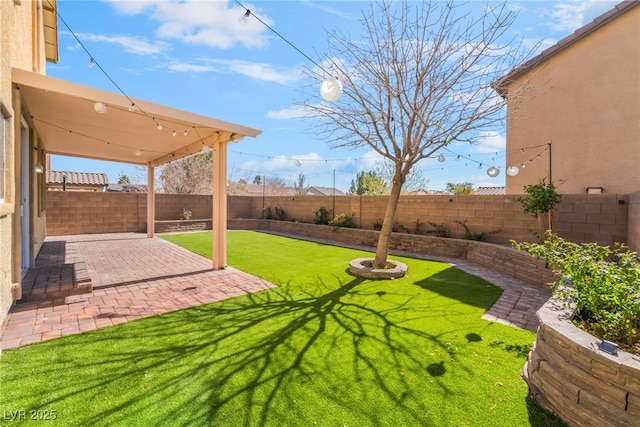 view of yard featuring a patio area and a fenced backyard