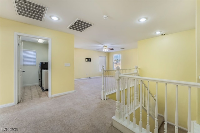 hallway featuring carpet floors, an upstairs landing, visible vents, and recessed lighting