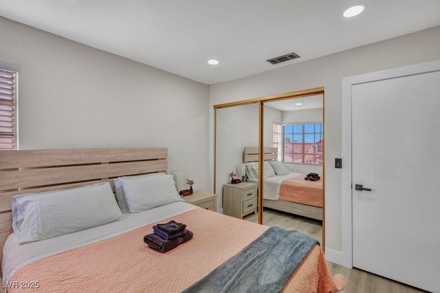 bedroom featuring light wood-type flooring and a closet