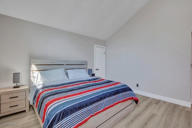 bedroom featuring vaulted ceiling and light hardwood / wood-style floors