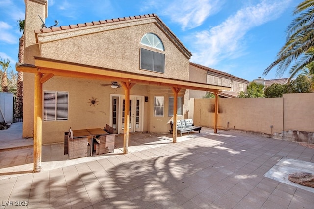 rear view of house featuring an outdoor living space, ceiling fan, and a patio area