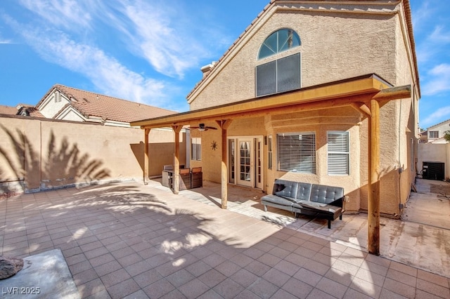 back of property with ceiling fan, a patio area, and central air condition unit