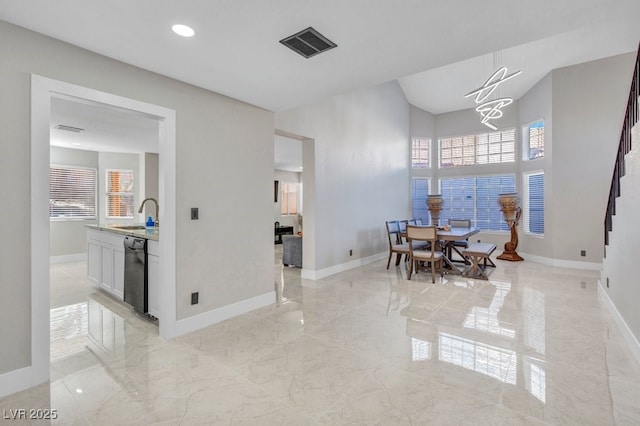 dining area with sink and an inviting chandelier