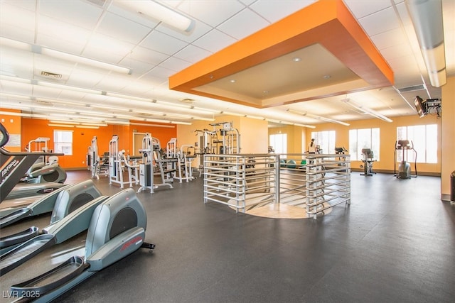 gym with a raised ceiling