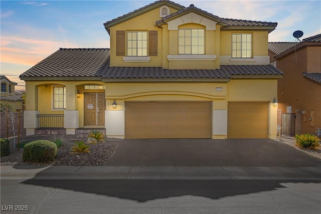 mediterranean / spanish-style house featuring a garage