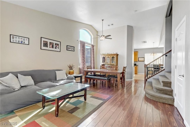 living room featuring lofted ceiling, hardwood / wood-style floors, and ceiling fan