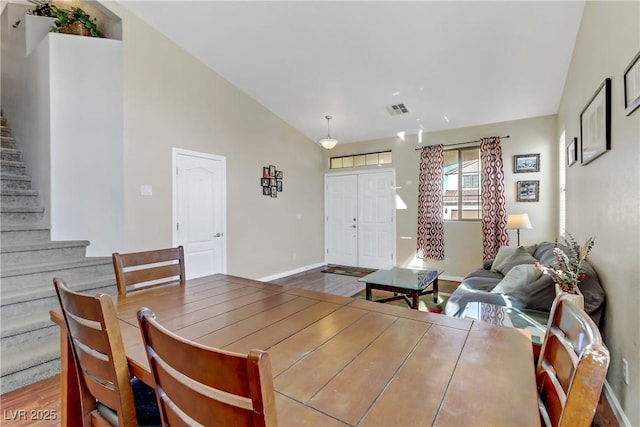 dining room featuring lofted ceiling and wood-type flooring