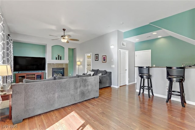 living room with ceiling fan and light hardwood / wood-style floors