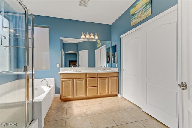 bathroom featuring independent shower and bath, vanity, and tile patterned floors