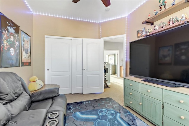 living room featuring carpet floors and ceiling fan