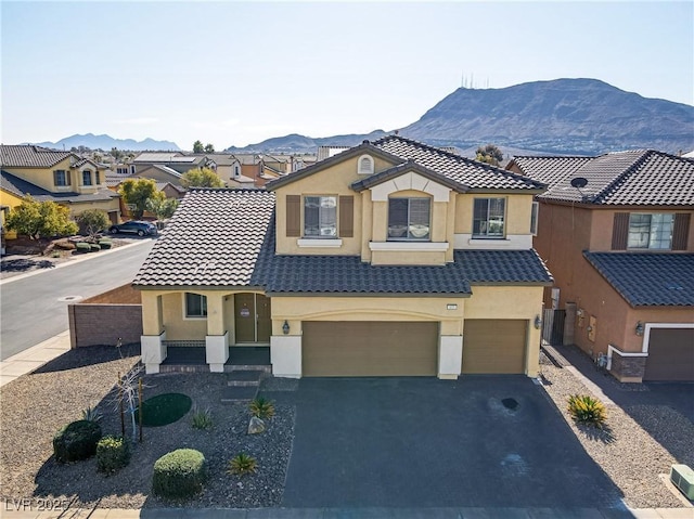 view of front of property featuring a mountain view and a garage